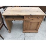 A PINE DESK WITH ONE DOOR AND ONE DRAWER