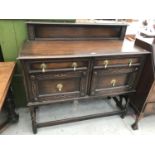 AN OAK SIDEBOARD ON BARLEY TWIST SUPPORTS WITH STRETCHER RAILS WITH TWO DOORS AND TWO DRAWERS WITH