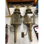 A PAIR OF VINTAGE BRASS RAILWAY LANTERNS WITH EAGLE DESIGN TOPS