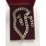 A BOXED LADIES MATCHING SILVER CURB BRACELET AND EARRINGS SET