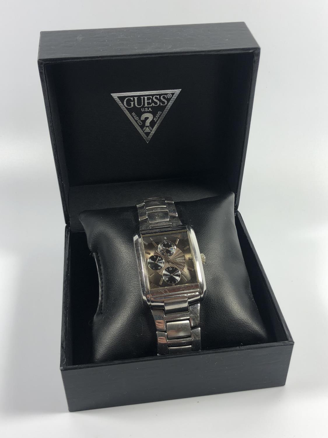 A GENTS BOXED 'GUESS' STAINLESS STEEL TANK STYLE WATCH