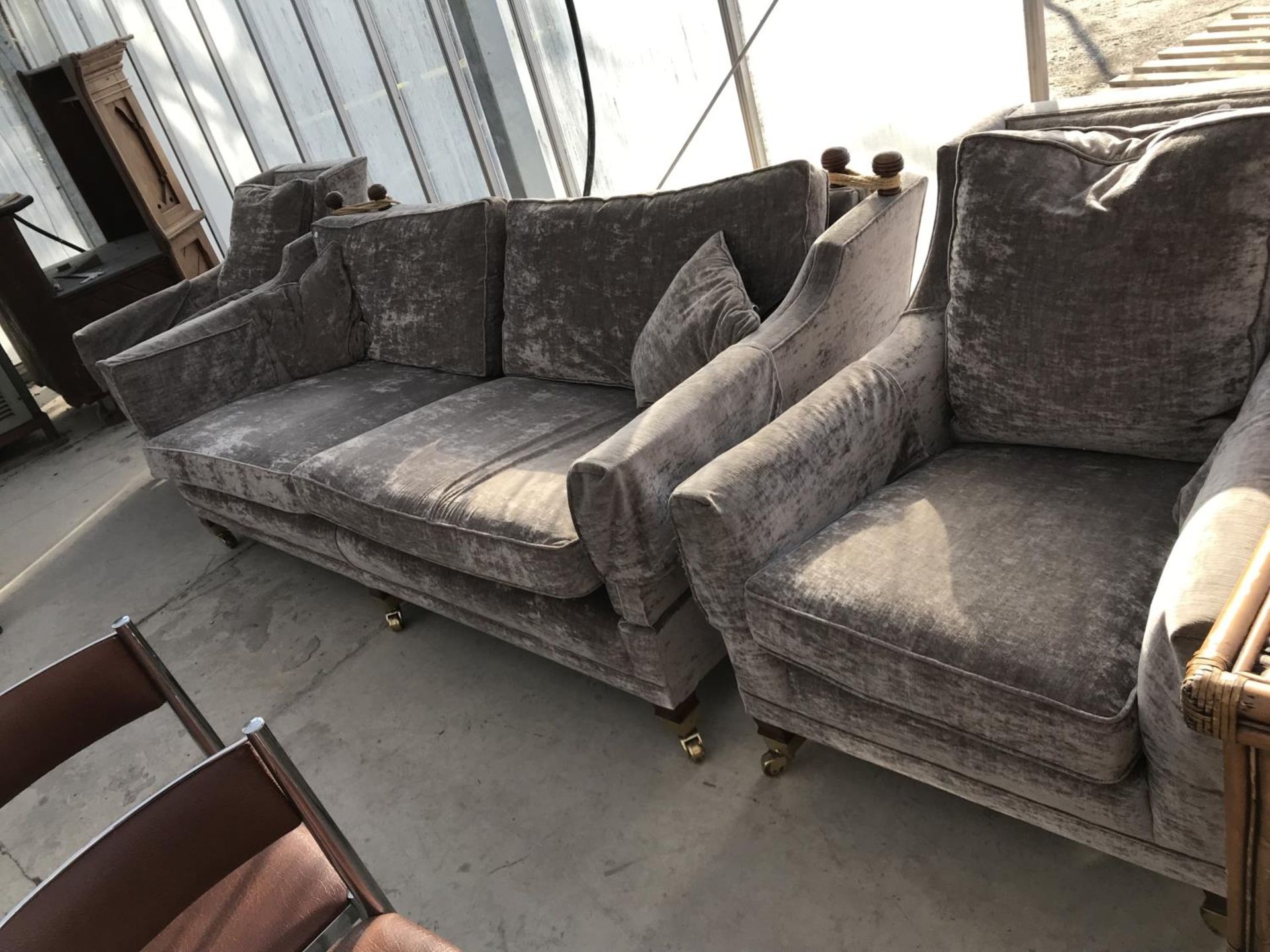 A KNOLE STYLE TWO SEATER SOFA AND TWO ARMCHAIRS ON BRASS CASTERS
