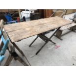 A VINTAGE WOODEN TRESTLE TABLE WITH FOLDING TOP 175CM X61CM