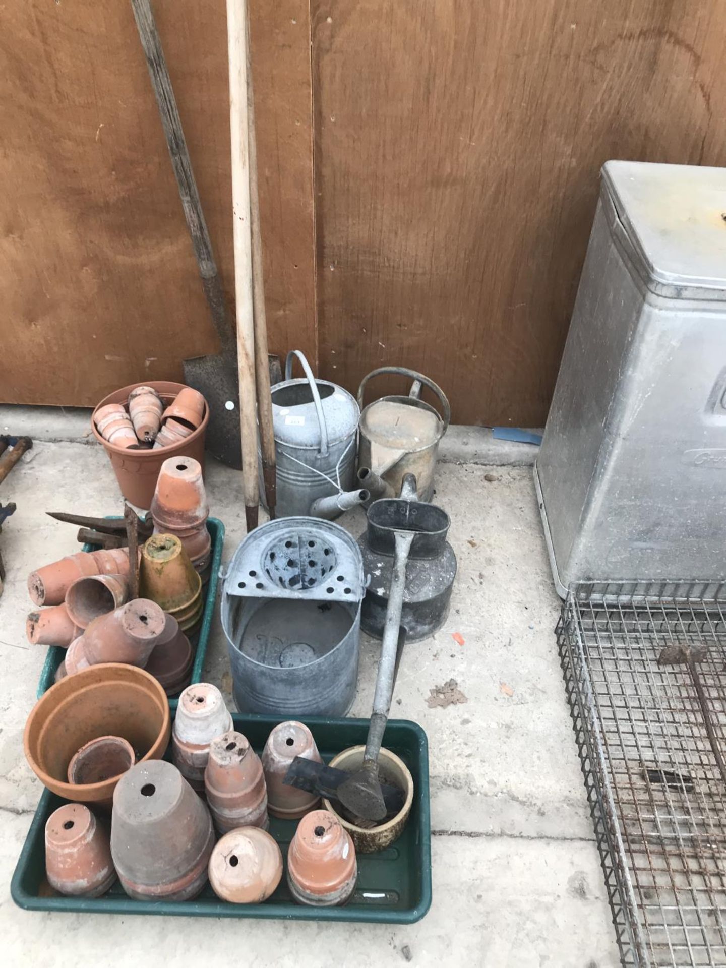 THREE VINTAGE GALVANISED WATERING CANS, GALVANISED MOP BUCKET, TERRACOTTA PLANT POTS, TWO HOES AND A