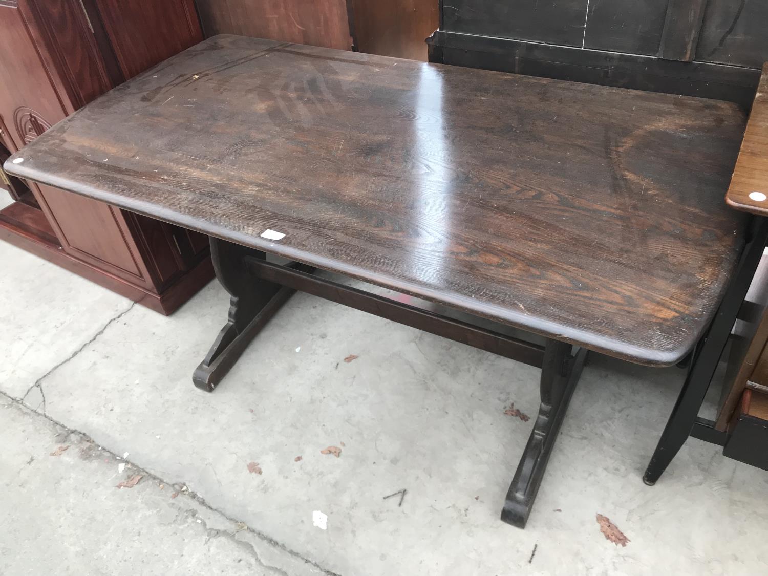 AN ERCOL ELM DINING TABLE