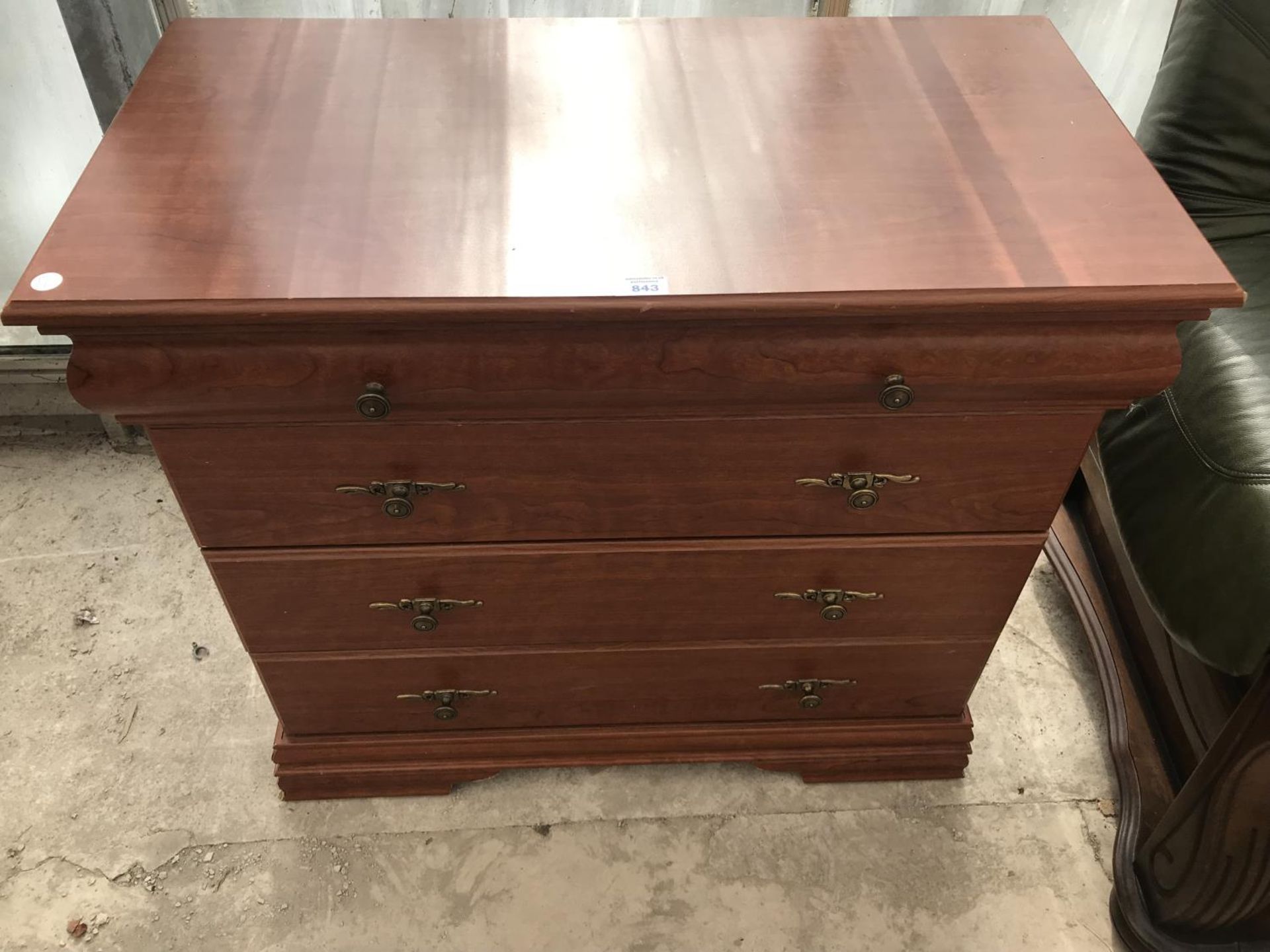 A MAHOGANY VENEERED CHEST OF FOUR DRAWERS