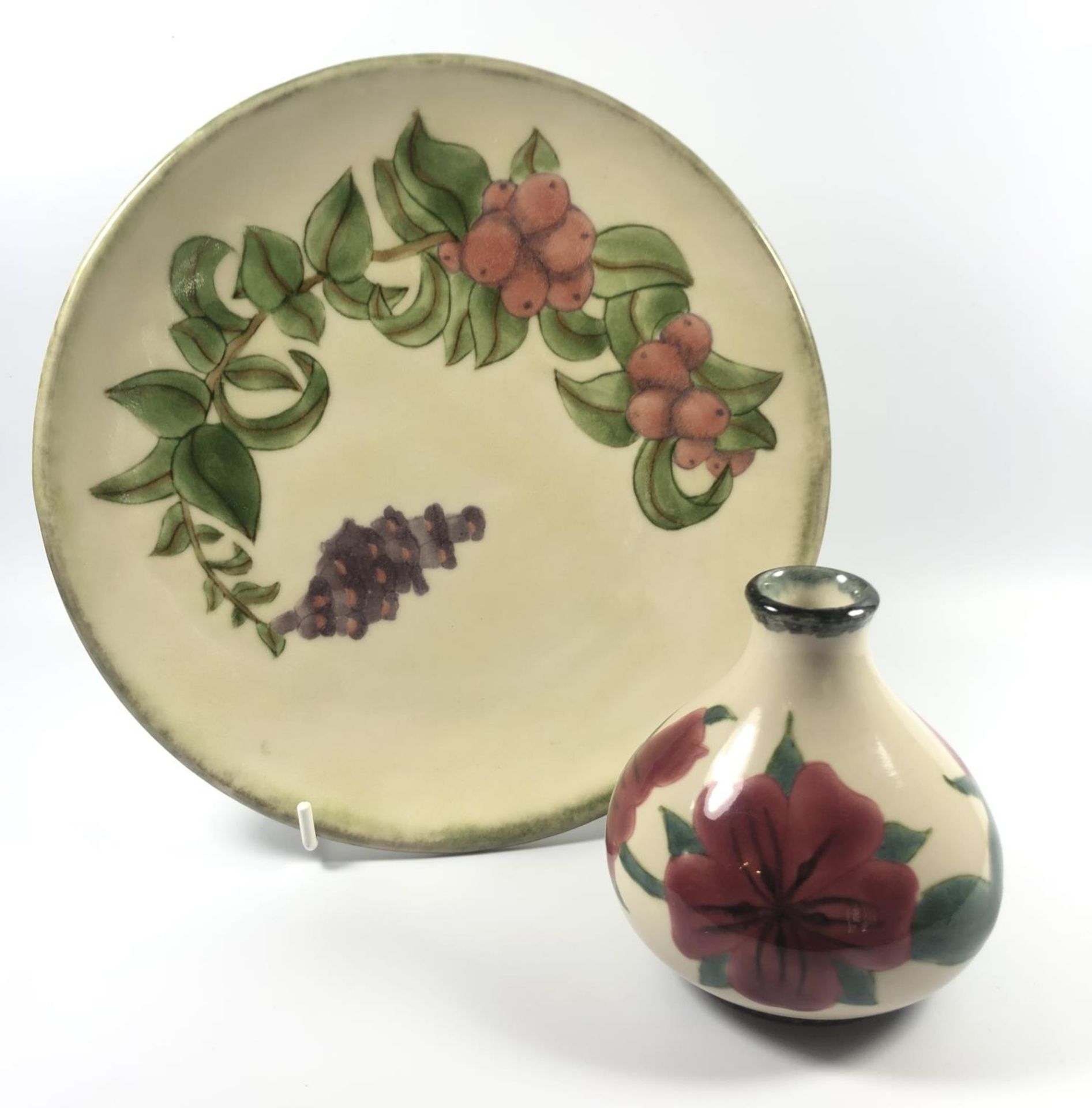 TWO PIECES OF COBRIDGE POTTERY - A PLATE AND SQUAT VASE IN THE BERRY AND PLUM PATTERN, HEIGHT OF
