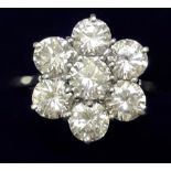 A LADIES 18 CT WHITE GOLD DIAMOND CLUSTER RING WITH CENTRAL STONE APPROX 0.5CT AND SURROUNDING SIX