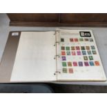 A STAMP ALBUM CONTAINING VARIOUS STAMPS FROM AROUND THE WORLD