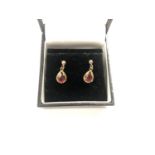 A PAIR OF LADIES 9CT YELLOW GOLD EARRINGS WITH RED STONE DESIGN