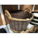 A LARGE TWIN HANDLED WICKER LOG BASKET