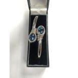 A LADIES SILVER BRACELET WITH TWO BLUE STONES