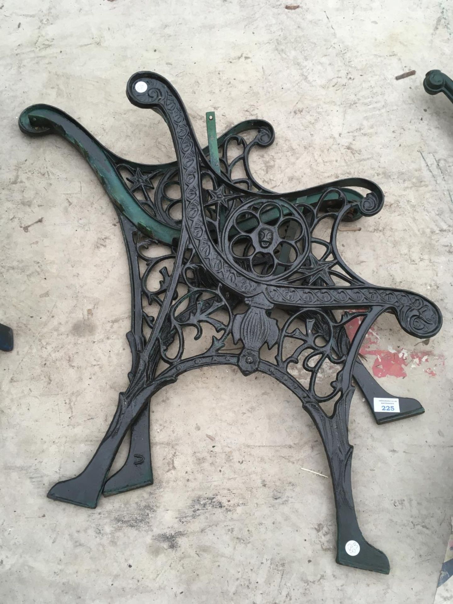 A PAIR OF ORNATE CAST IRON BENCH ENDS