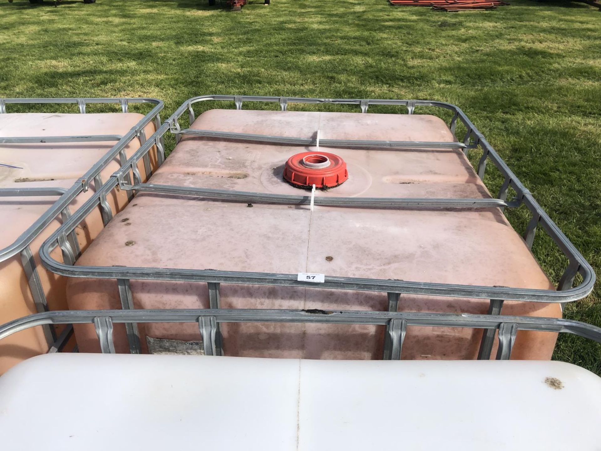 A WATER TANK ON METAL PALLET CAGE