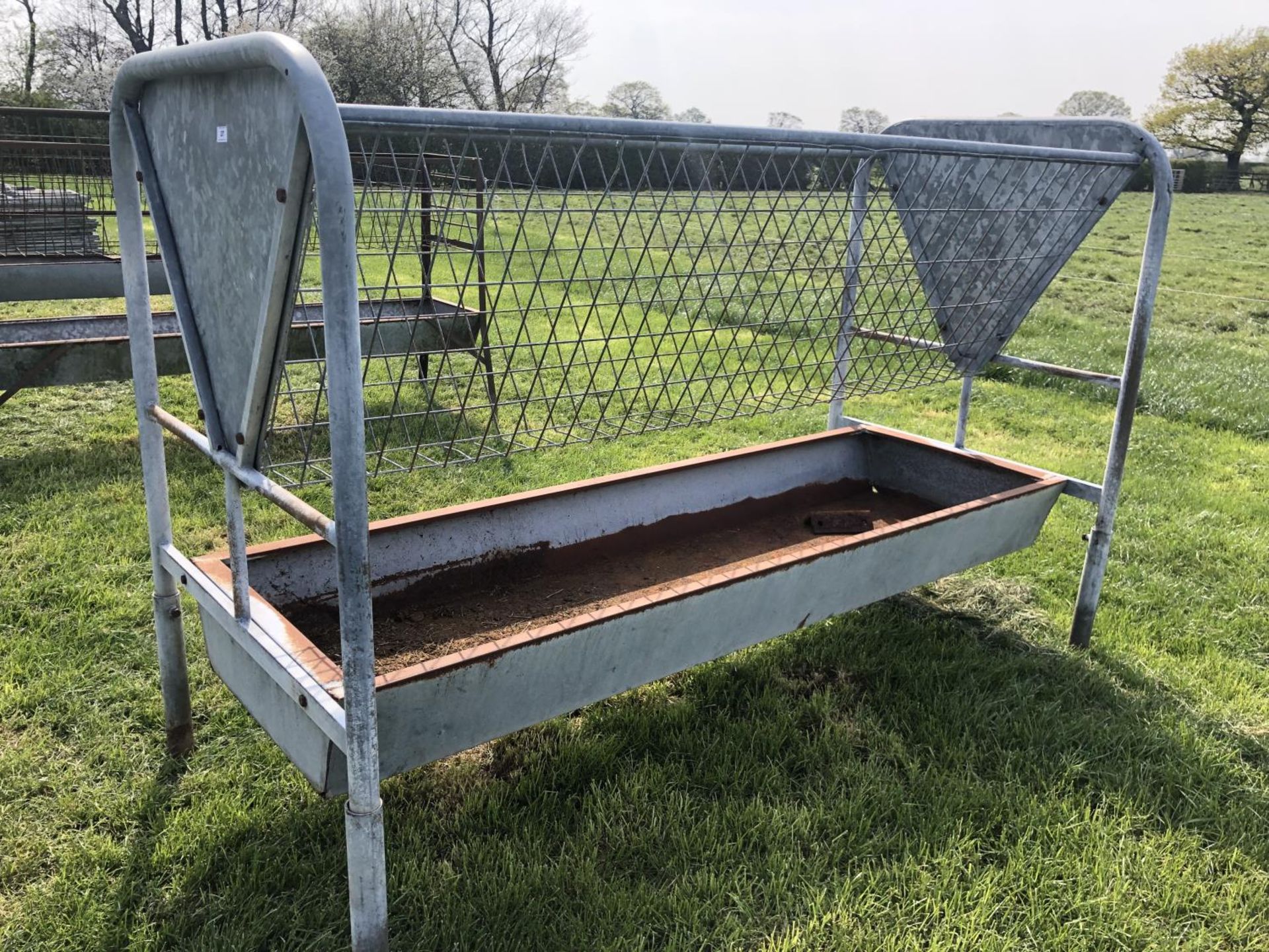 A LARGE GALVANISED FEED TROUGH WITH MANGER