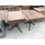 A WALNUT EXTENDING DINING TABLE ON TWIN PEDESTAL SUPPORTS