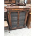 AN INLAID MAHOGANY CABINET WITH TWO GLAZED DOORS AND GILDED DECORATION