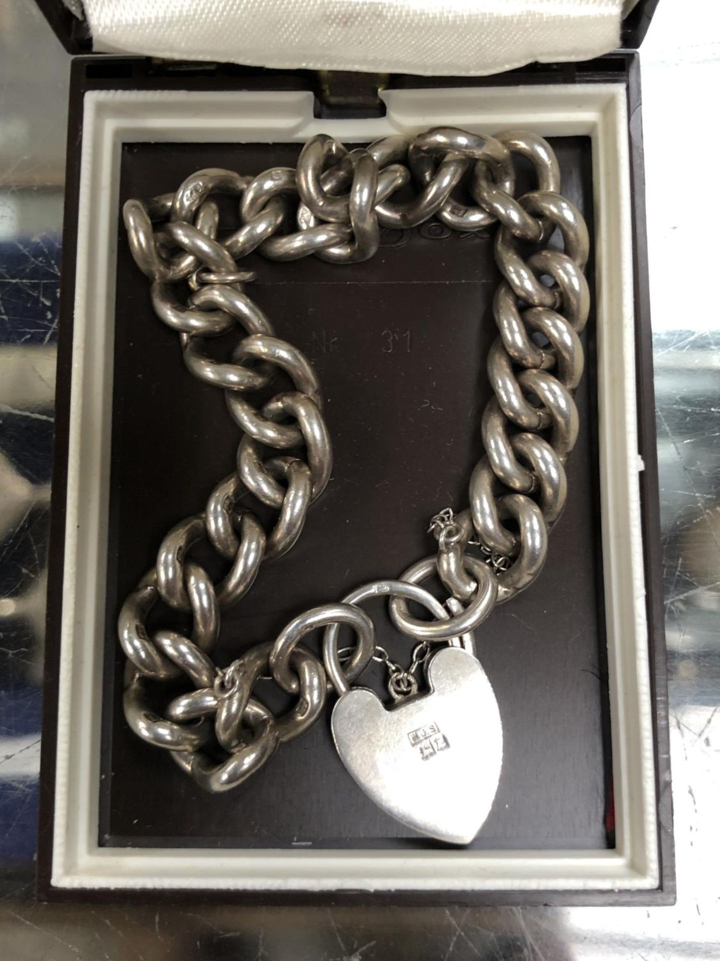 A BOXED LADIES HALLMARKED SILVER HEART CLASP CHARM BRACELET