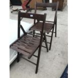 A PAIR OF FOLDING WOODEN CHAIRS