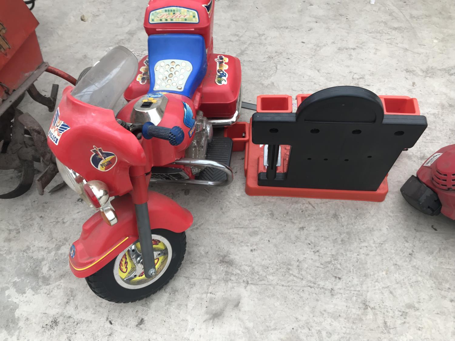 A BLACK AND DECKER CHILDS WORK BENCH WITH VICE AND A POLICE RIDE ON MOTORBIKE