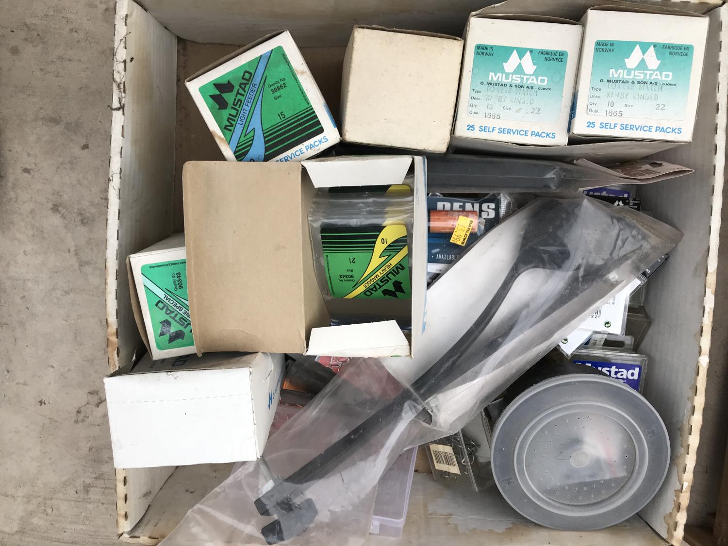 A BOX CONTAINING VARIOUS FISHING TACKLE - HOOKS, GROUND BAIT CASTERS ETC