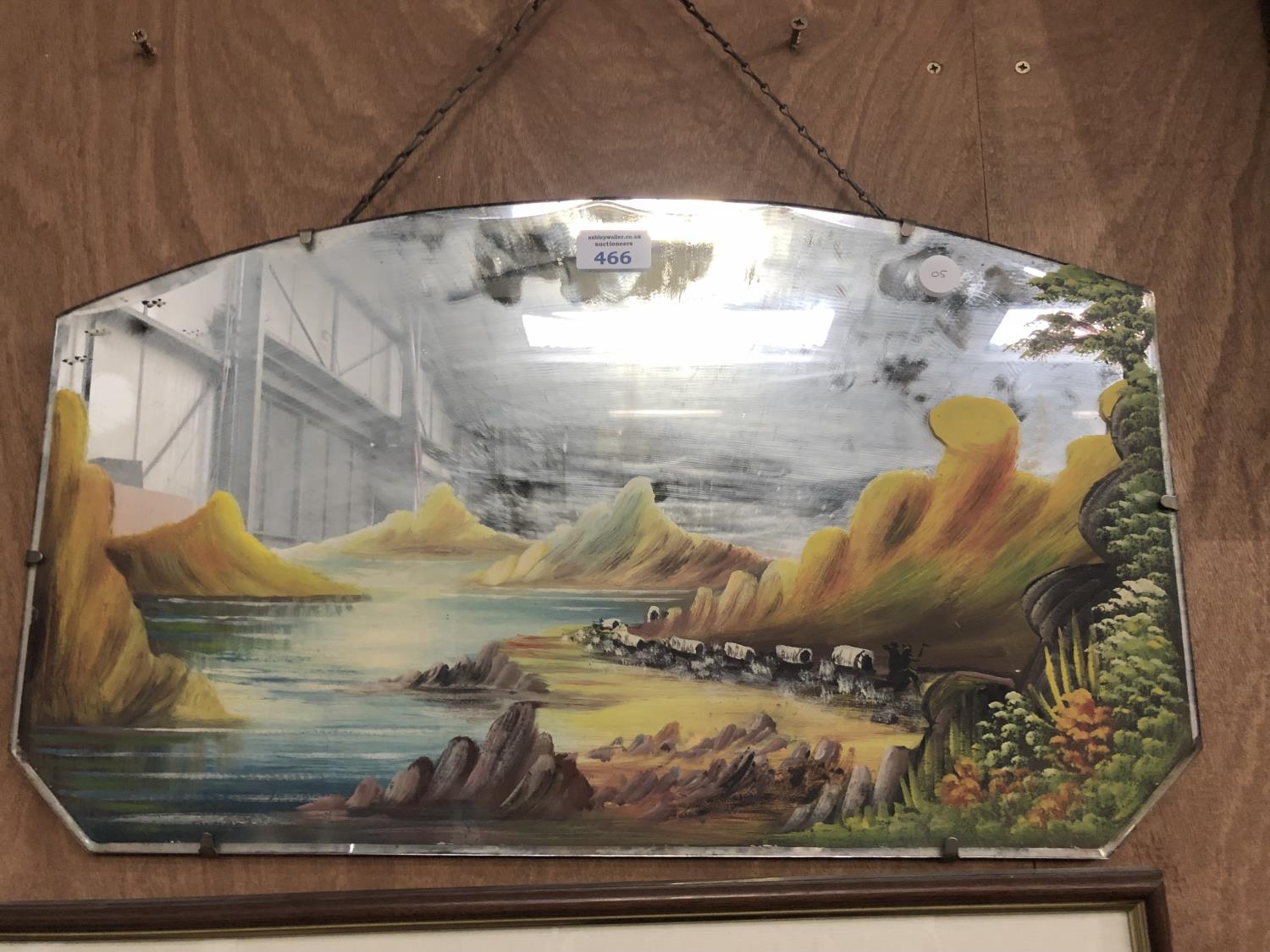 A 1930'S MIRROR WITH PAINTED 'TRAIN OVER THE ROCKIES' DESIGN