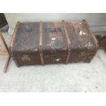 A VINTAGE WOODEN BOUND TRAVEL TRUNK