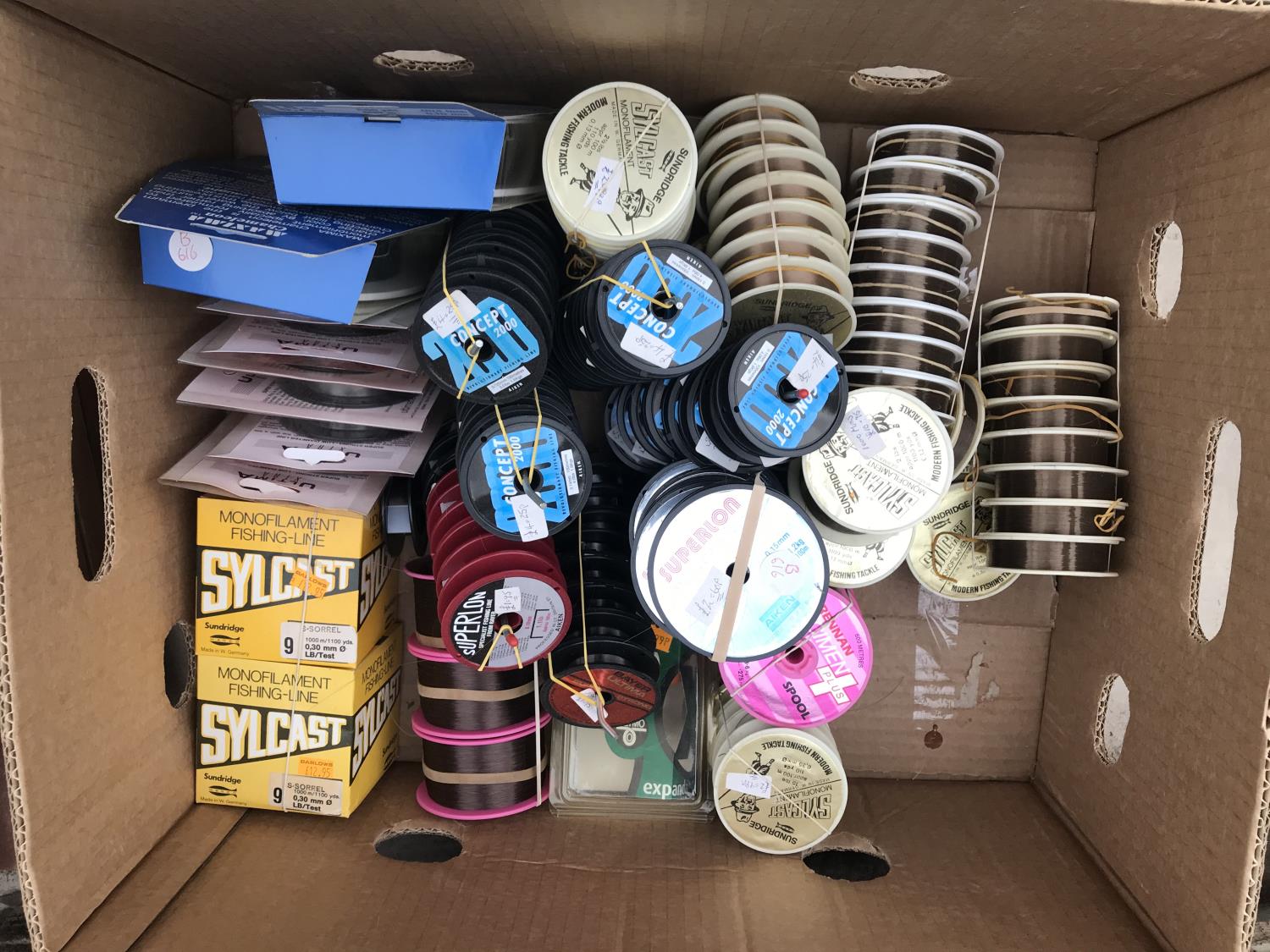 A BOX CONTAINING 100 + VARIOUS SPOOLS OF LINE