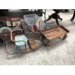 A VINTAGE METAL CHILDREN'S SEAT AND TROLLEY