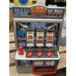 A RETRO TOY 'FRUIT MACHINE' SLOTS GAME WITH GAME TOKENS