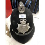 A VINTAGE POLICEMANS HELMET