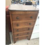 A TALL OAK CHEST OF FIVE DRAWERS
