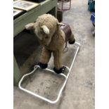 A VINTAGE FURRY ROCKING HORSE ON METAL ROCKERS