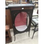 AN ORNATE INLAID MAHOGANY CABINET WITH FLORAL DECORATION AND SINGLE DOOR WITH OVAL GLASS PANEL