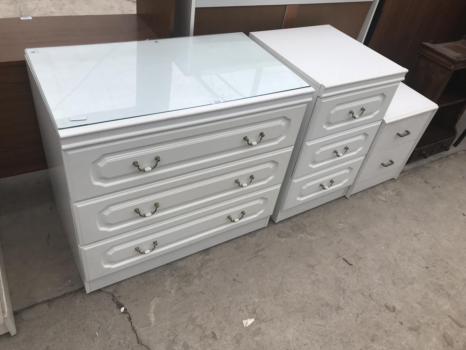 A WHITE CHEST OF THREE DRAWERS AND TWO WHITE BEDSIDE CHESTS OF DRAWERS