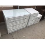 A WHITE CHEST OF THREE DRAWERS AND TWO WHITE BEDSIDE CHESTS OF DRAWERS