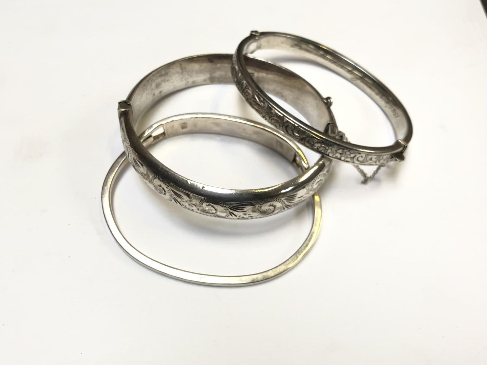 THREE LADIES ASSORTED SILVER BANGLES