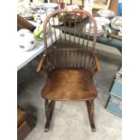 A GOOD QUALITY ELM ROCKING CHAIR WITH WISHBONE STRETCHER