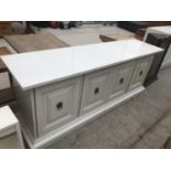 A WHITE SIDEBOARD WITH FOUR DOORS