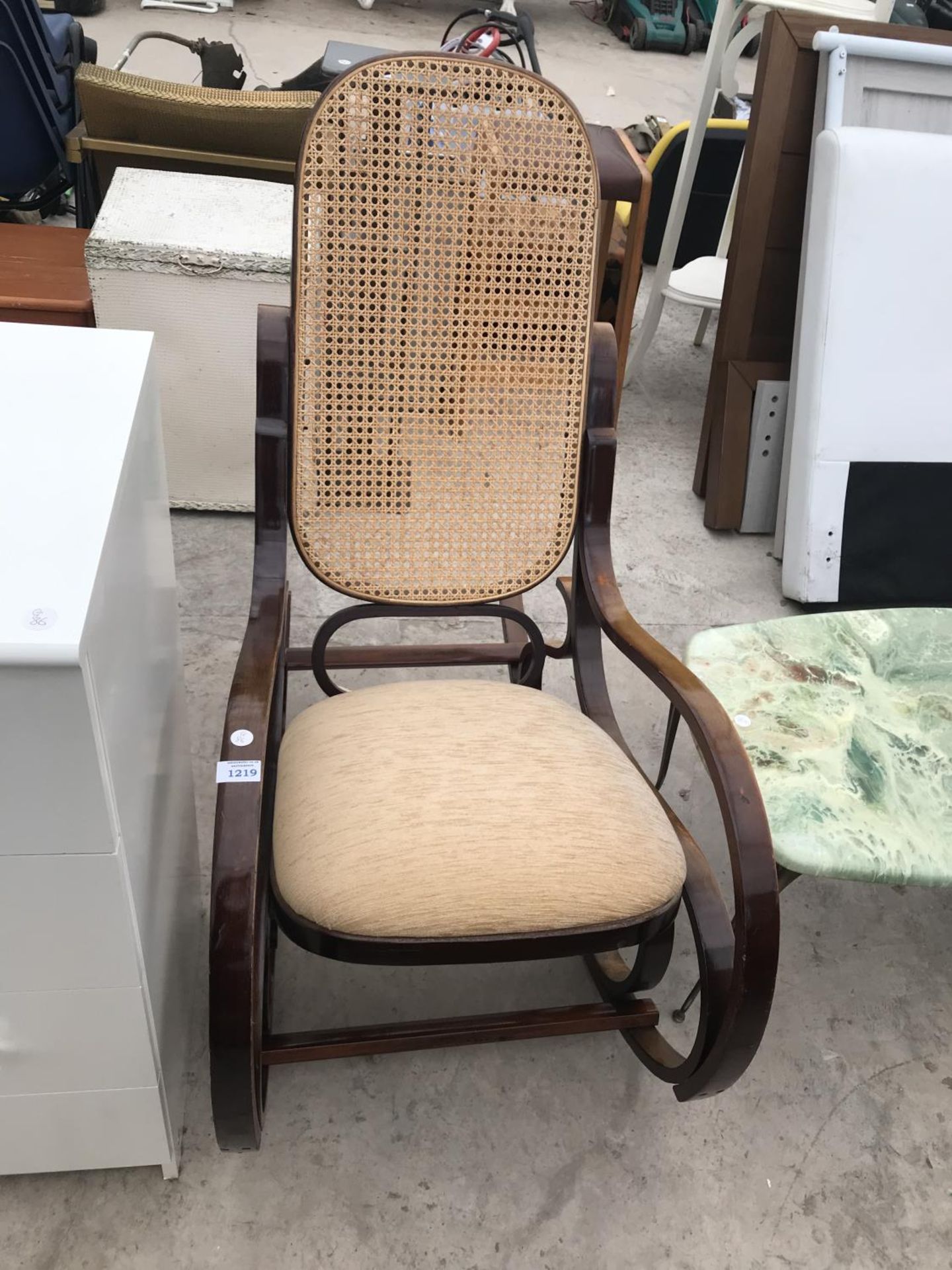 A MAHOGANY BENTWOOD ROCKING CHAIR WITH RATTAN BACK AND UPHOLSTERED SEAT