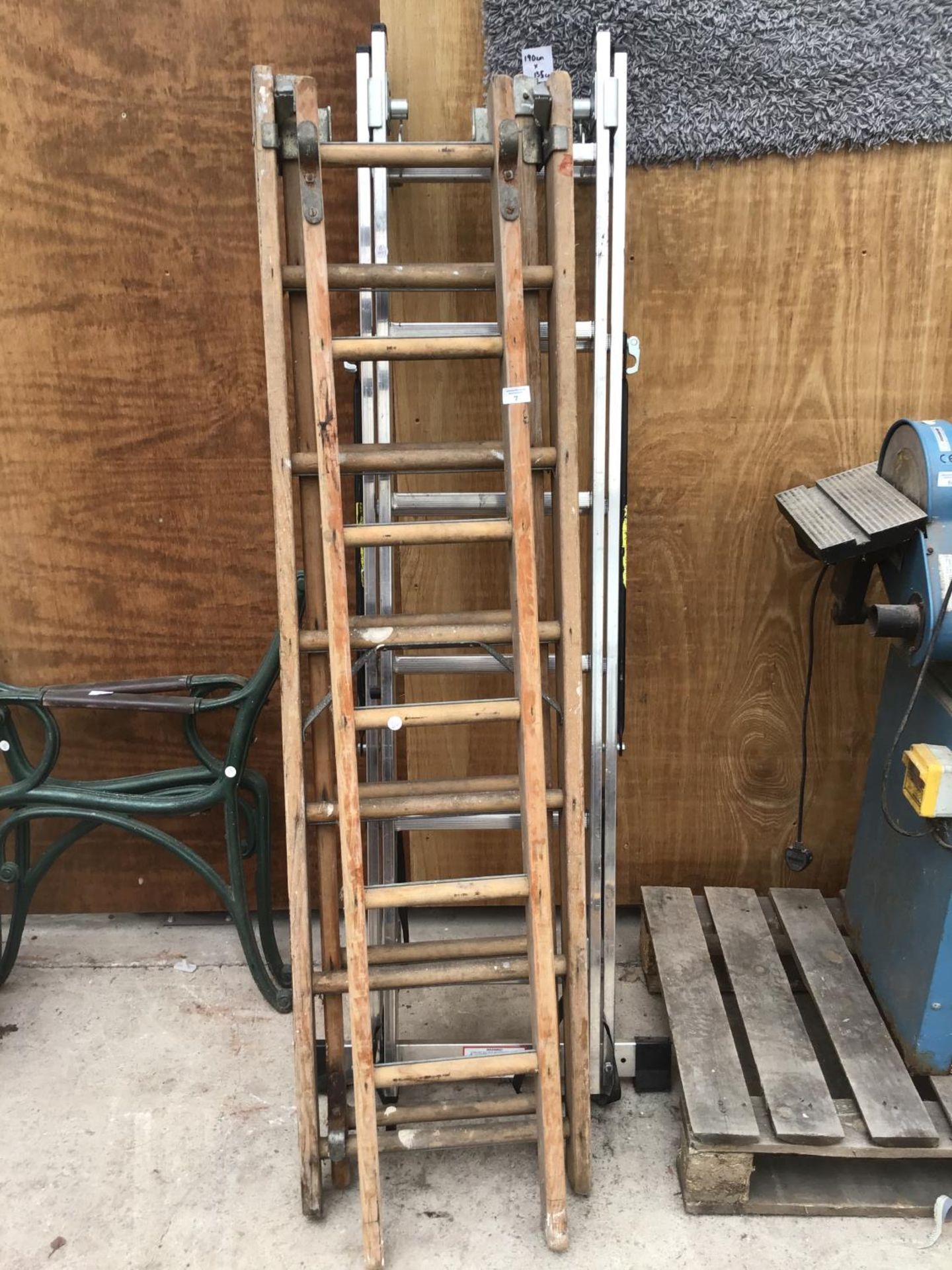 A VINTAGE EIGHTEEN RUNG THREE SECTION LADDER AND AN ALLOY TWELVE RUNG TWO SECTION LADDER