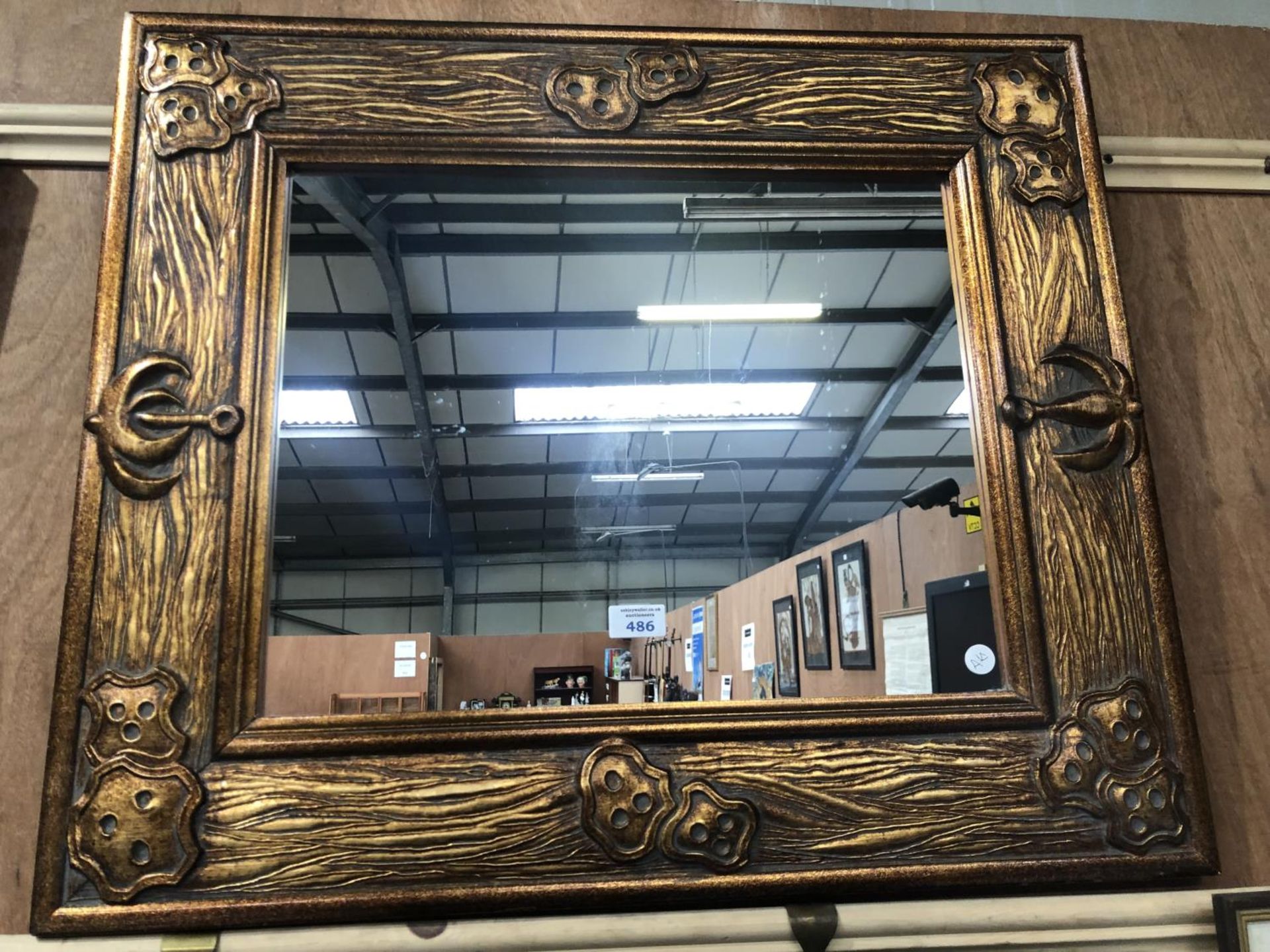 A MODERN DECORATIVE GOLD FRAMED MIRROR