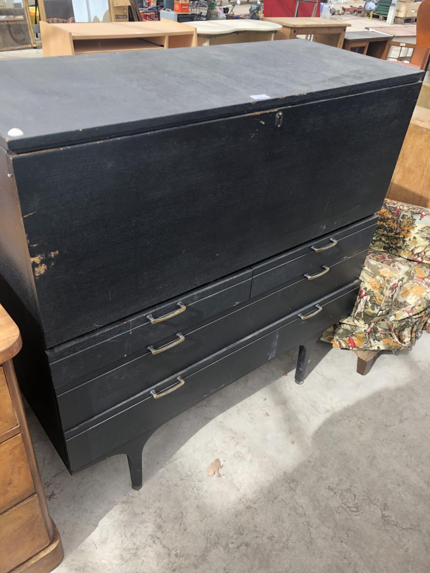 A BLACK CABINET WITH FALL FRONT AND DRAWERS