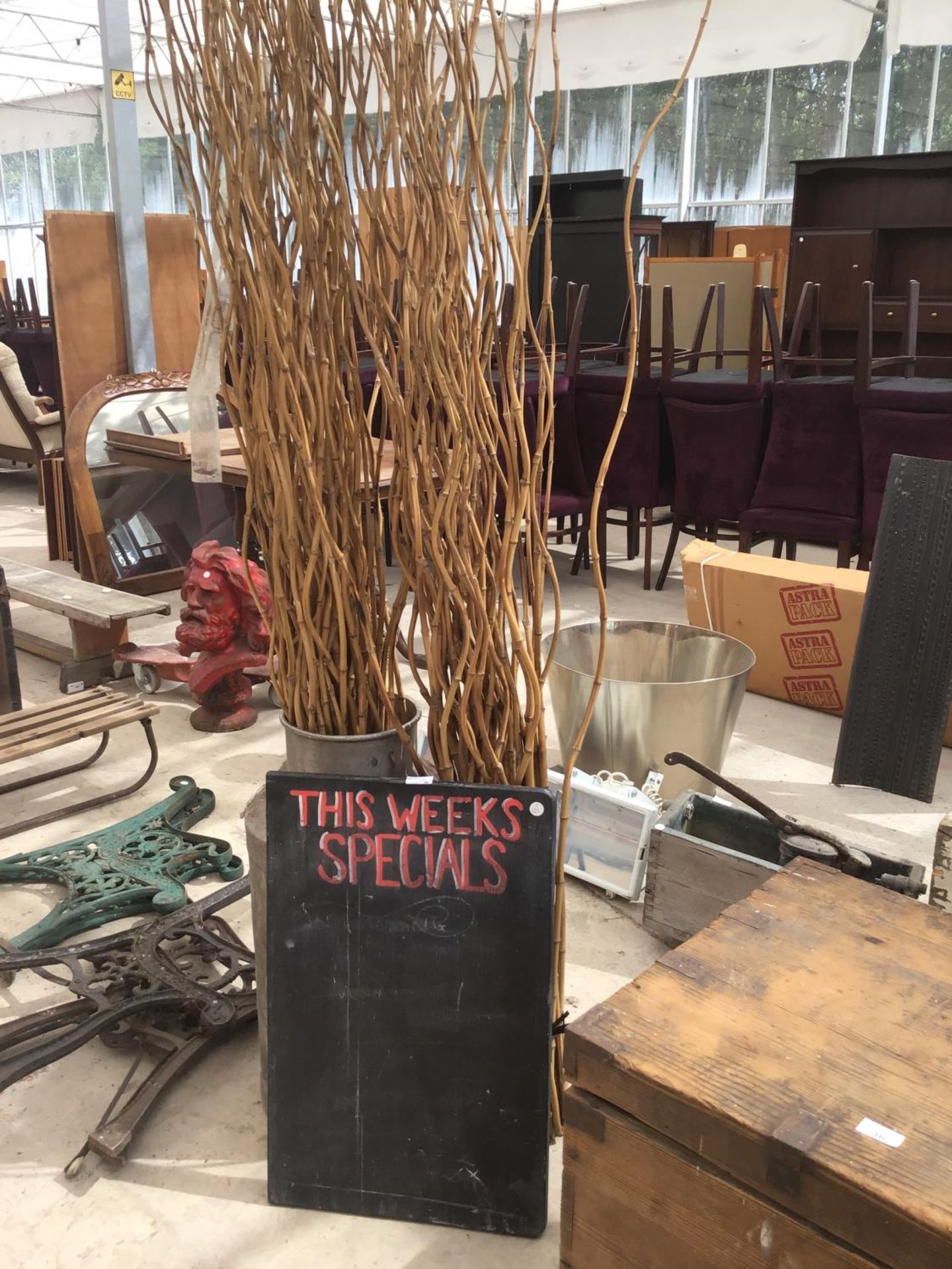 A VINTAGE MILK CHURN (NO LID), A LARGE QUANTITY OF TWISTED BAMBOO, AND A 'SPECIALS' NOTICE BOARD