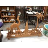 A CARVED WOODEN CAMEL DESIGN DISPLAY