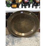 AN ARTS AND CRAFT STYLE LARGE BRASS CHARGER