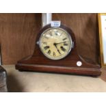 A WOODEN MANTLE CLOCK