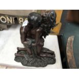 A BRONZE EFFECT MODEL OF A MAN AND A WOMAN