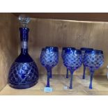 A BLUE GLASS DECANTER AND SIX WINE GLASSES