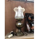 A BRASS OIL LAMP WITH GLASS SHADE
